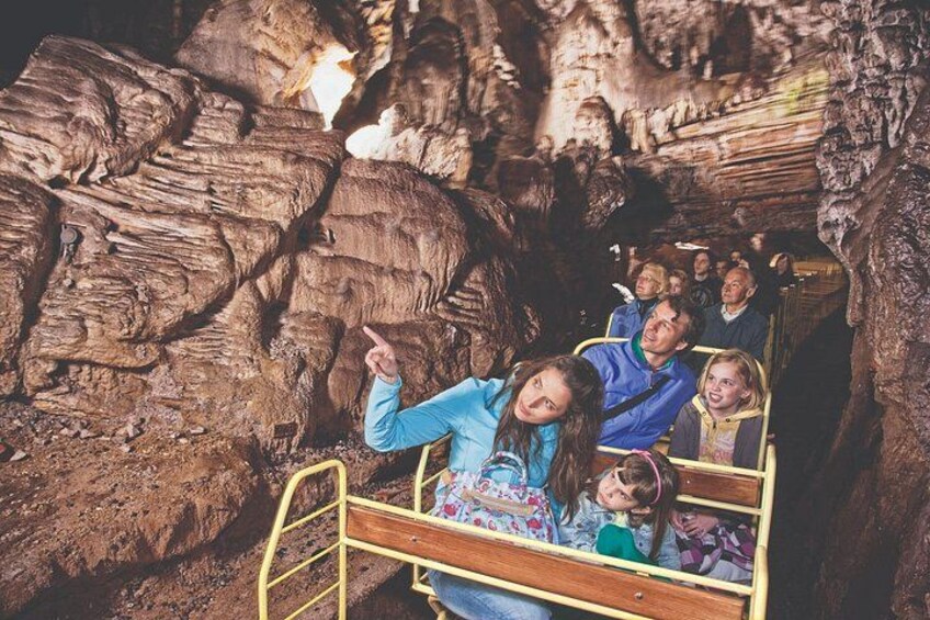 Une grotte avec des formations rocheuses et des personnes se trouvant dans un petit espace clos. 4