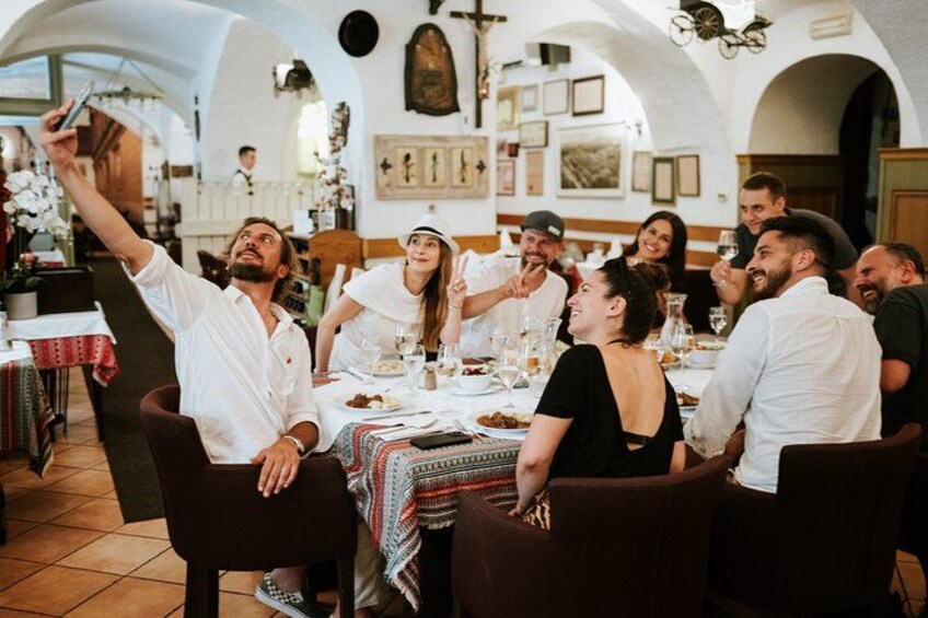 A group of people dining in a restaurant with white walls and arches. 2