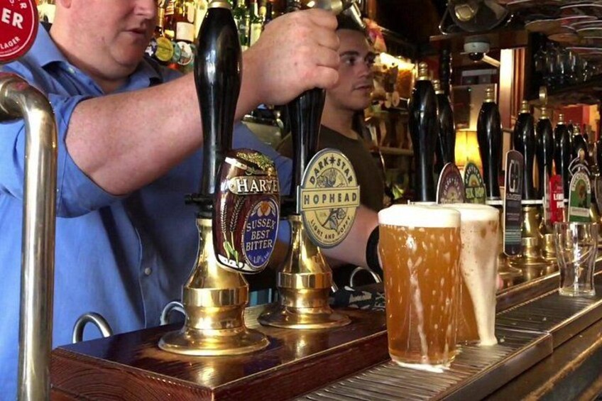 A bartender pouring beer from a tap labeled 'Darkstar Hophead.' 2