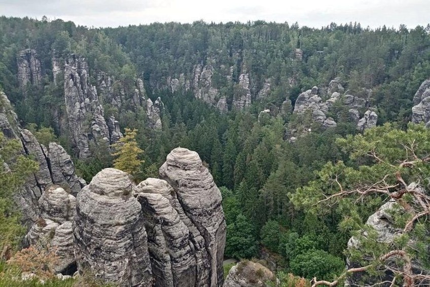 A forested valley with prominent rock formations. 2