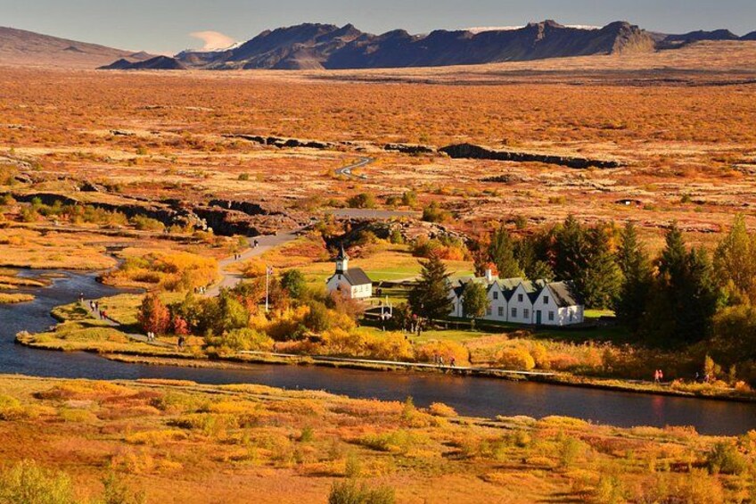 A river, a white house, and a mountainous landscape. 2