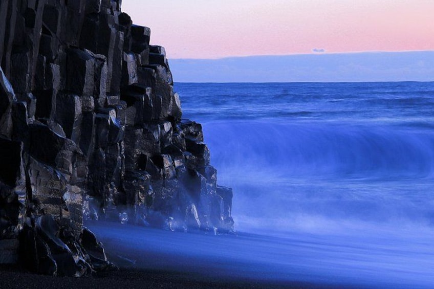 A rocky coastline with waves crashing against the rocks. 3