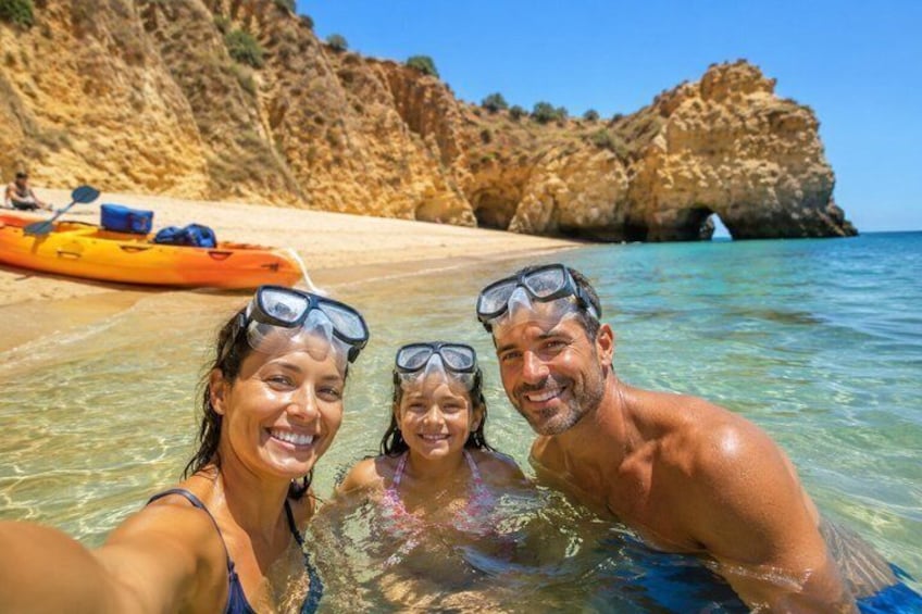 A beach with clear water, a rocky cliff, and a kayak in the background. 2