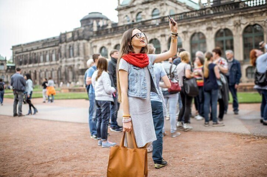 A person taking a selfie with a historic building in the background. 4