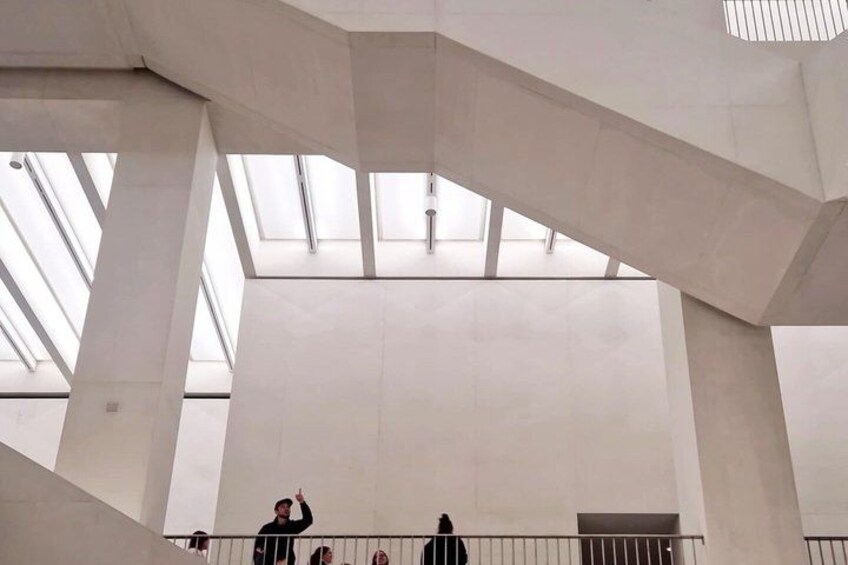 A spacious interior with high ceilings and skylights. 2