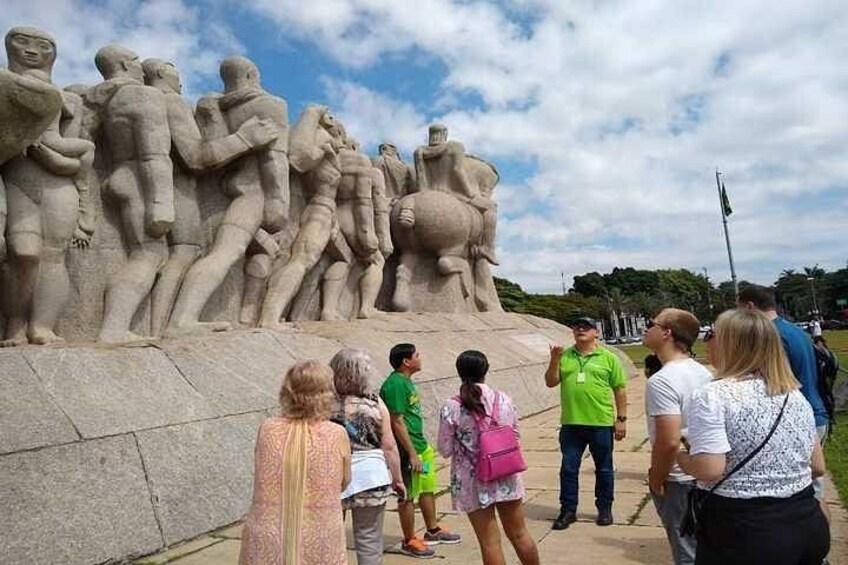 A large stone sculpture of figures in a historical site. 1
