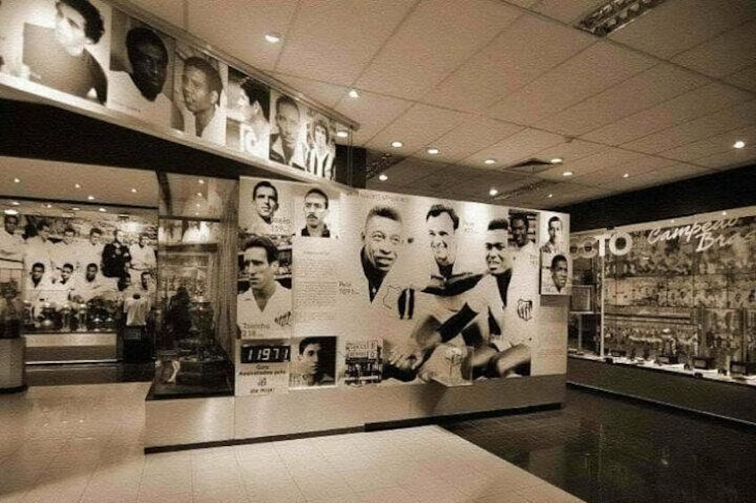 A wall with multiple black and white photographs and text, likely a sports-related exhibit. 5