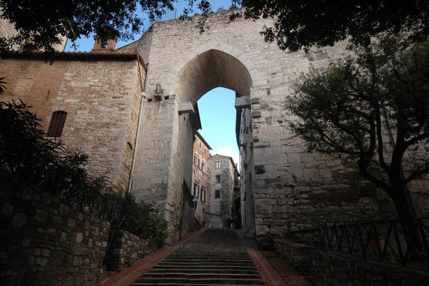 An arched stone bridge in a historic town. 2
