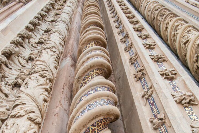 A close-up of ornate stone carvings with intricate patterns and designs. 2
