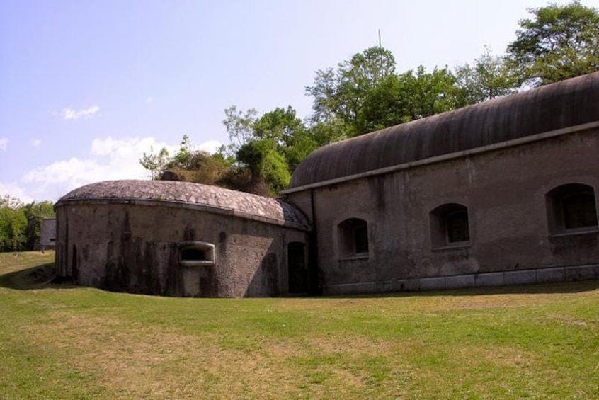 An old, weathered building with a dome-shaped structure and a rectangular extension. 4