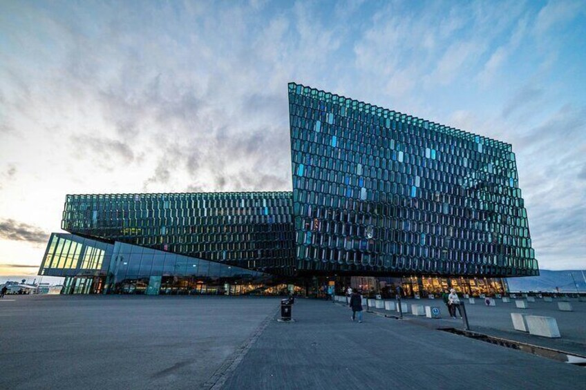 A modern glass building with a unique geometric design. 5