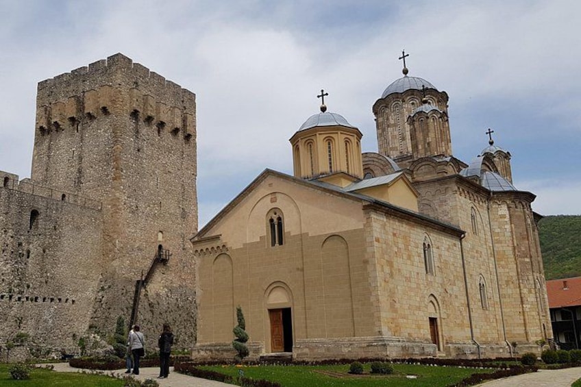 A historic church with a bell tower and a large stone tower. 4