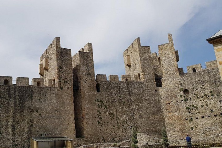 A medieval stone castle with multiple towers and battlements. 5