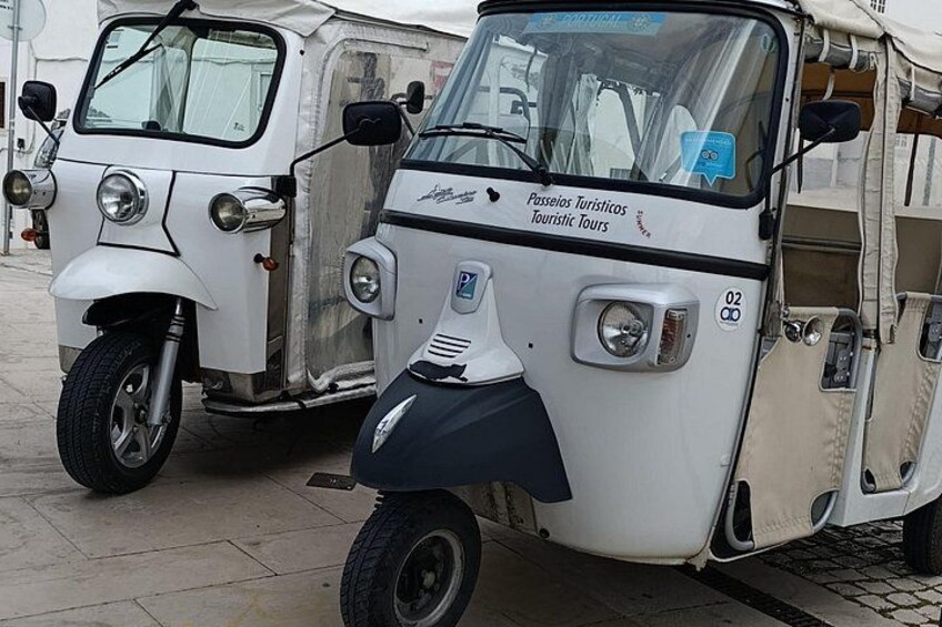 Two vintage vehicles parked on a paved surface. 5