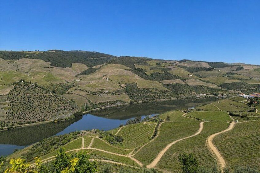 A valley with terraced fields, a lake, and rolling hills. 2