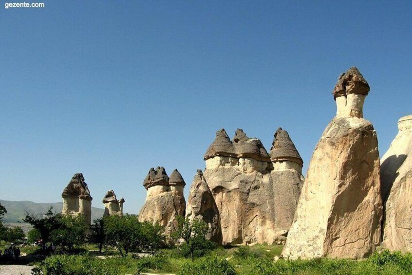 A landscape of unique rock formations with pointed tops and varying heights. 1