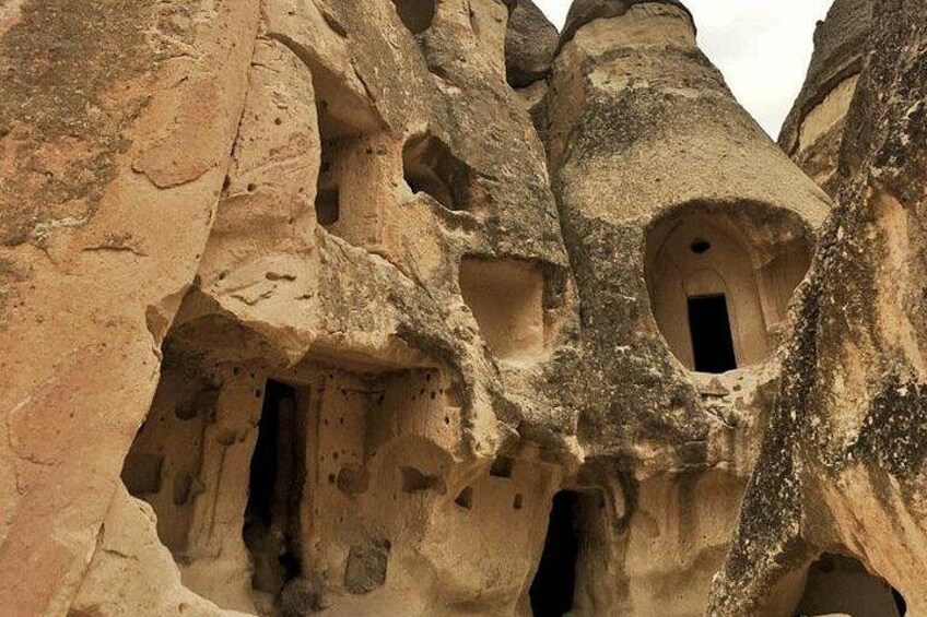 Rock formations with multiple cave-like openings. 3