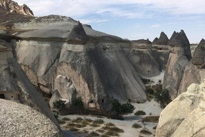 A landscape with prominent rock formations and a clear sky. 4