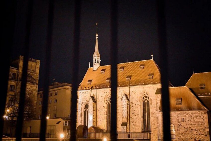 A historic building with a tall spire and arched windows. 4