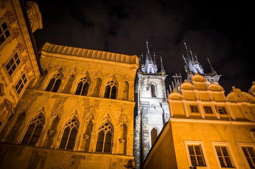 A historic building with ornate architecture and a tower with spires. 2