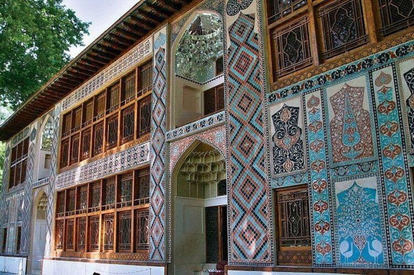 A building with intricate tile work and wooden lattice windows. 4