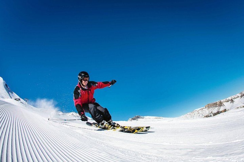 A person skiing down a snow-covered slope. 2