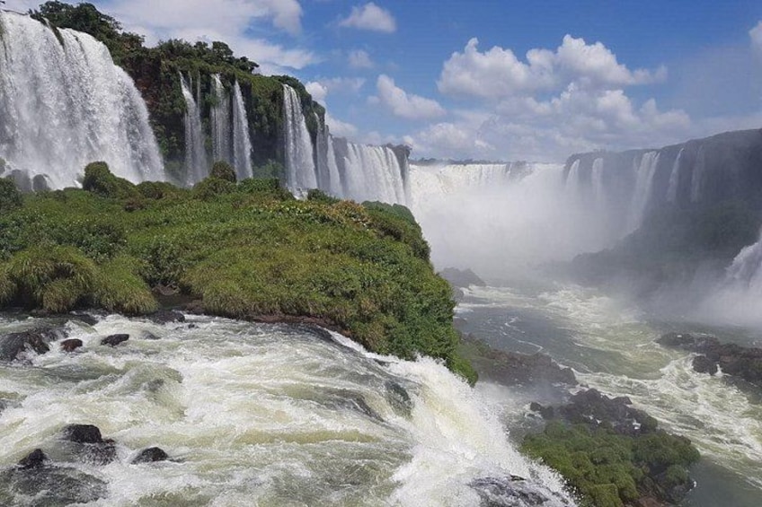 A large waterfall with multiple cascades surrounded by lush greenery. 5