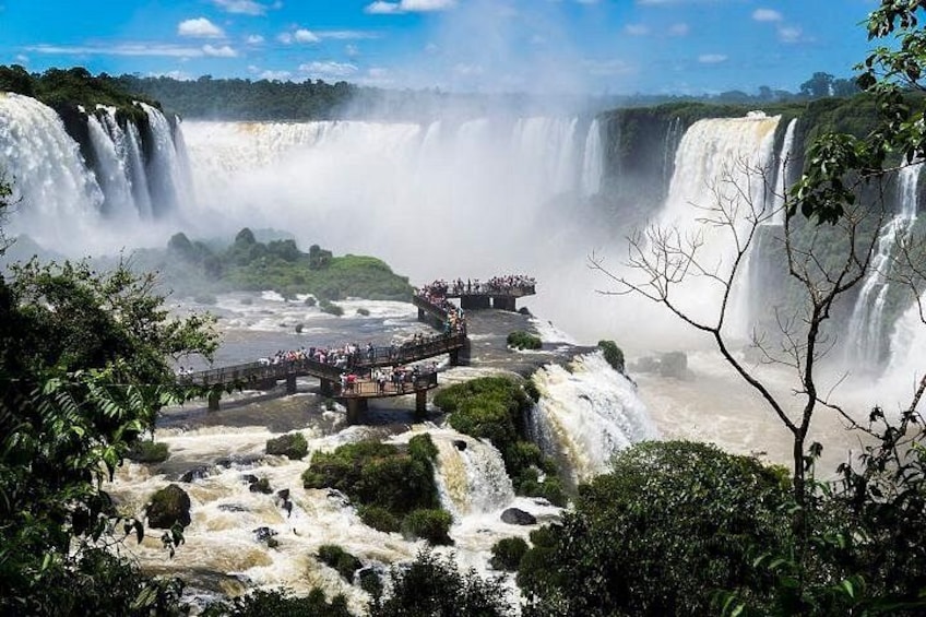 A large waterfall with a viewing platform and a bridge. 1
