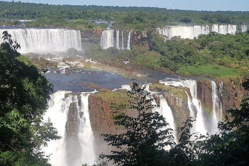 A series of waterfalls surrounded by lush greenery. 2