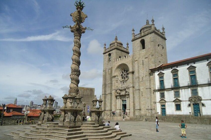A historic square with a prominent fountain and a large church with a bell tower. 4