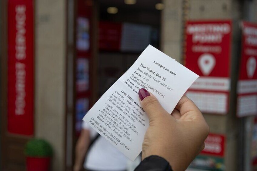 A person holding a tour ticket for a bus tour. 2