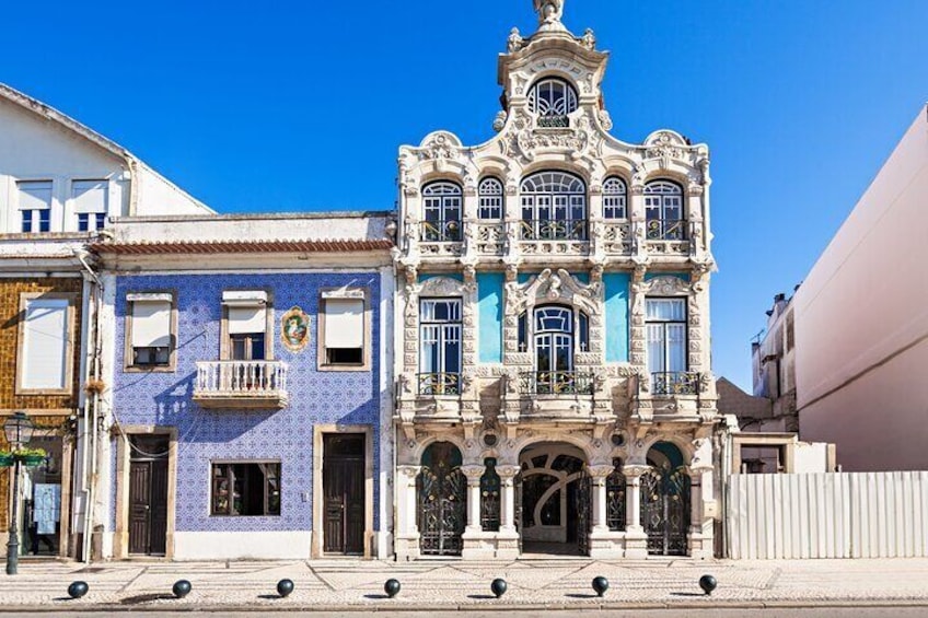 A historic building with ornate architecture, a clock, and a tiled facade. 3