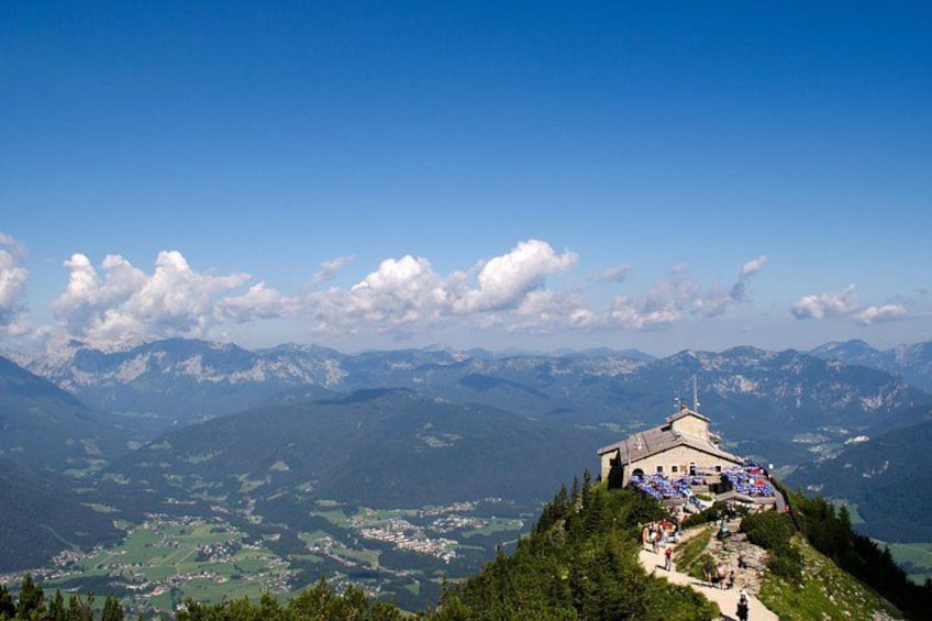 A mountain peak with a chapel and a clear sky. 4