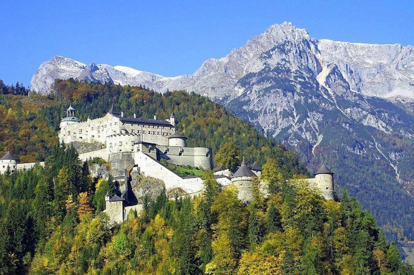 A castle on a hill with a mountain backdrop. 3