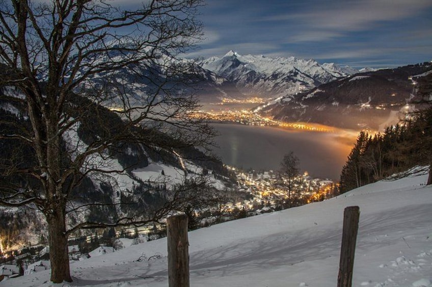 A snow-covered mountain landscape with a town in the valley below. 2