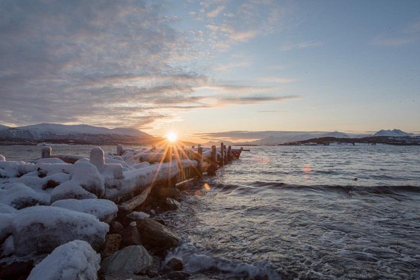 A frozen river with ice formations and a sunset in the background. 5