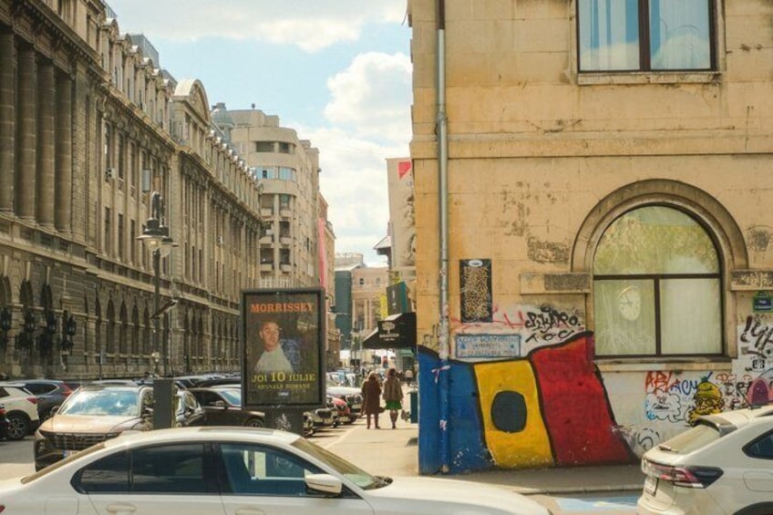 A street with cars, a building with graffiti, and a sign for 'Morrisey.' 2