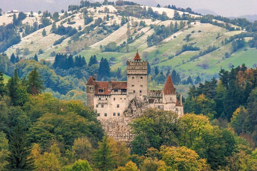 A castle surrounded by lush greenery and hills. 4