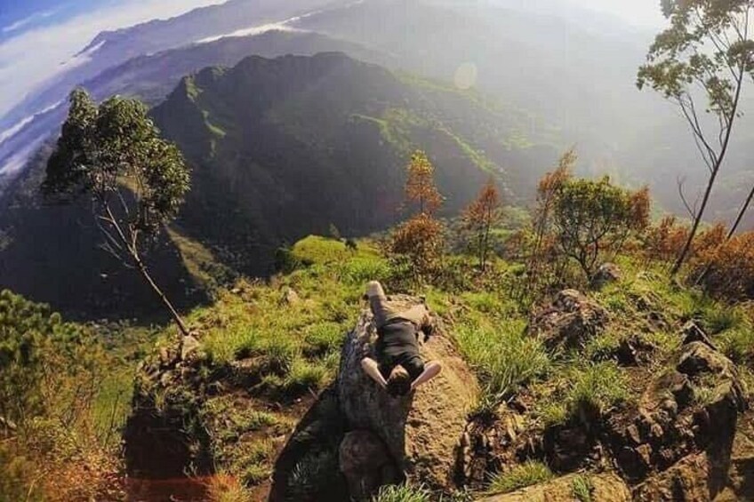 A mountainous landscape with a rocky outcrop and sparse vegetation. 1