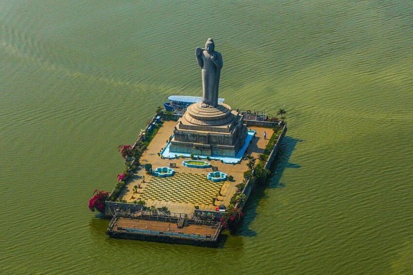A statue on a floating platform in a body of water. 3
