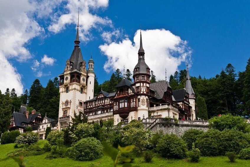 A large, historic castle with multiple towers and a well-maintained garden. 5