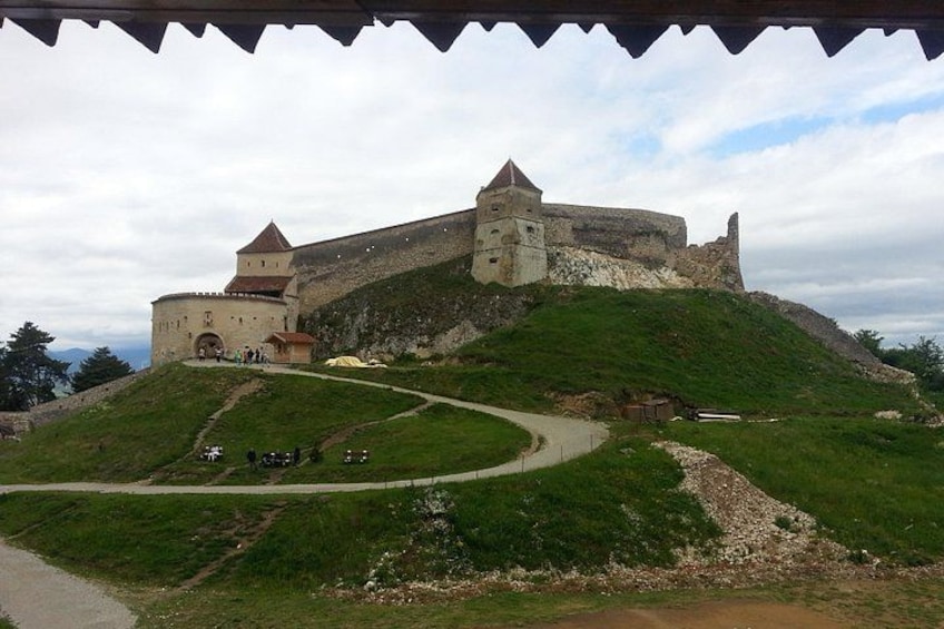 A historic castle on a hill with a winding road leading to it. 3
