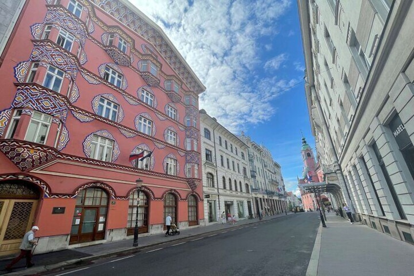Una calle con edificios coloridos, cielo despejado y una torre a lo lejos. 1