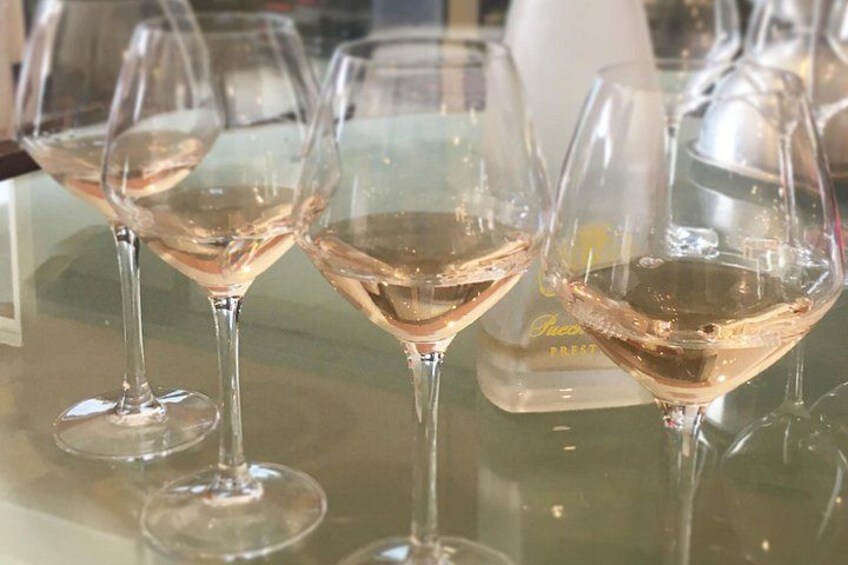 Three wine glasses on a reflective surface. 3