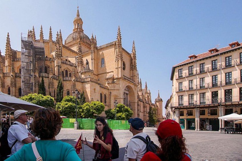 Una catedral histórica con arquitectura intrincada, una plaza adoquinada y un grupo de turistas. 2