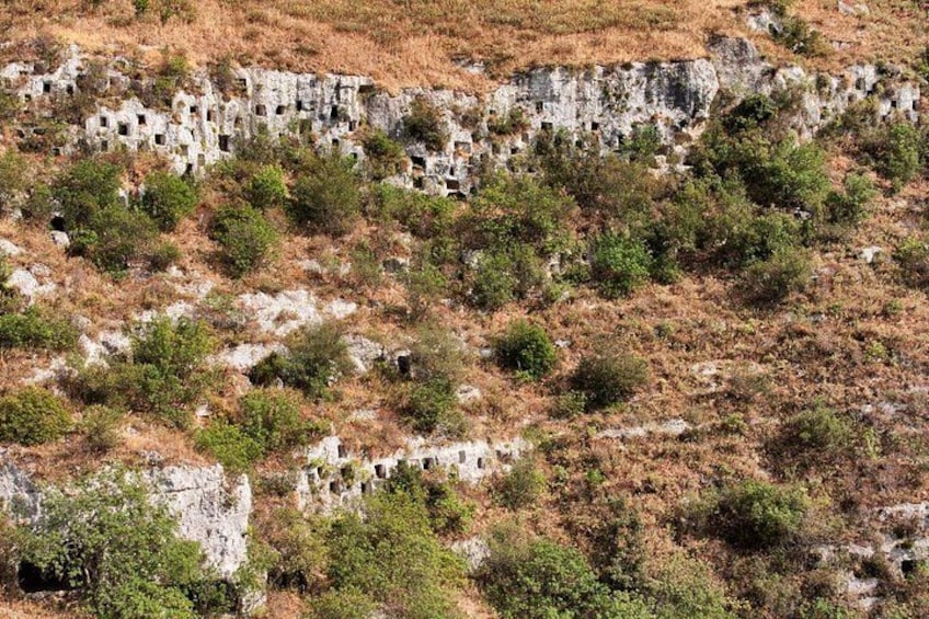 A rocky landscape with numerous stone ruins scattered across the terrain. 1