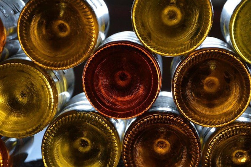 A collection of metallic objects with reflective surfaces and a central red-tinted object. 5