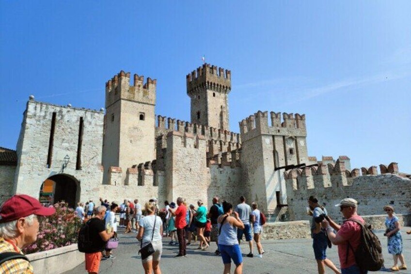 A historic castle with battlements and a large entrance gate. 5