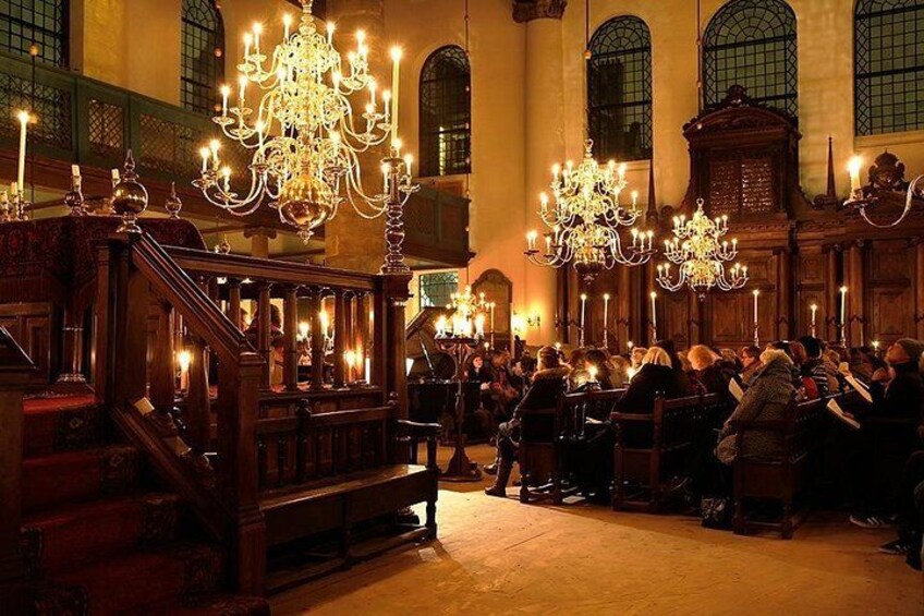 A church interior with ornate chandeliers, wooden pews, and a congregation. 2