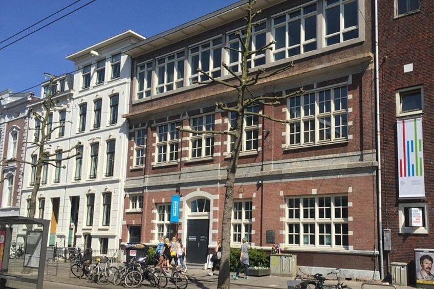 A multi-story building with large windows and a brick facade. 3